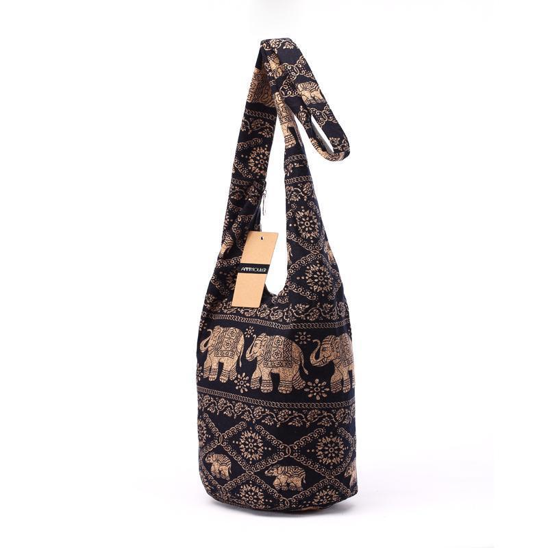 Black shoulder bag with gold elephant pattern on a white background