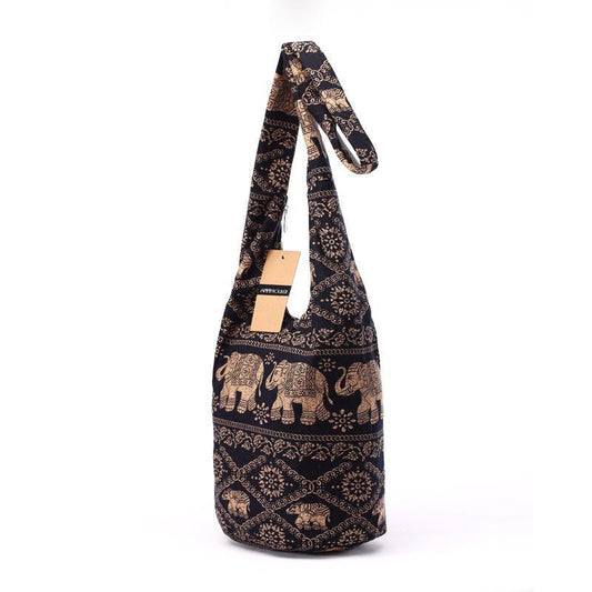 Black shoulder bag with gold elephant pattern on a white background